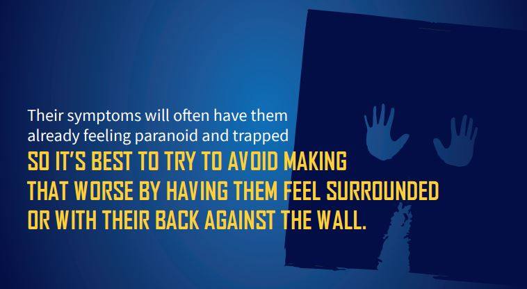 graphic of two hands that seem trapped with copy that reads: their symptoms will often have them feeling paranoid and trapped. so it's best to try to avoid making that worse by having them feel surrounded or with their back to the wall.